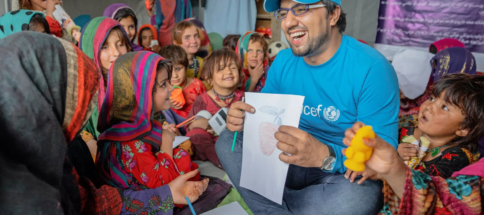 UNICEF worker helping children